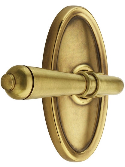 Oval Rosette Set With Turino Levers Left Hand in Antique Brass.